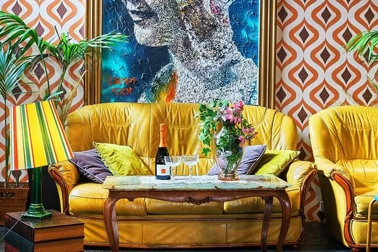 Angolo salotto vintage con divani gialli e opera d'arte